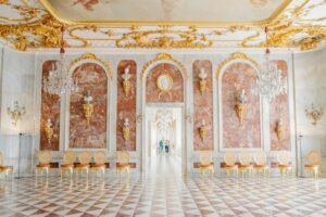 A large room with a checkered floor and a chandelier