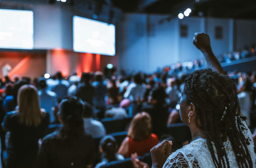 Vibrant crowd at a conference with a focus on an attentive participant.