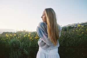Young woman in a field of yellow flowers