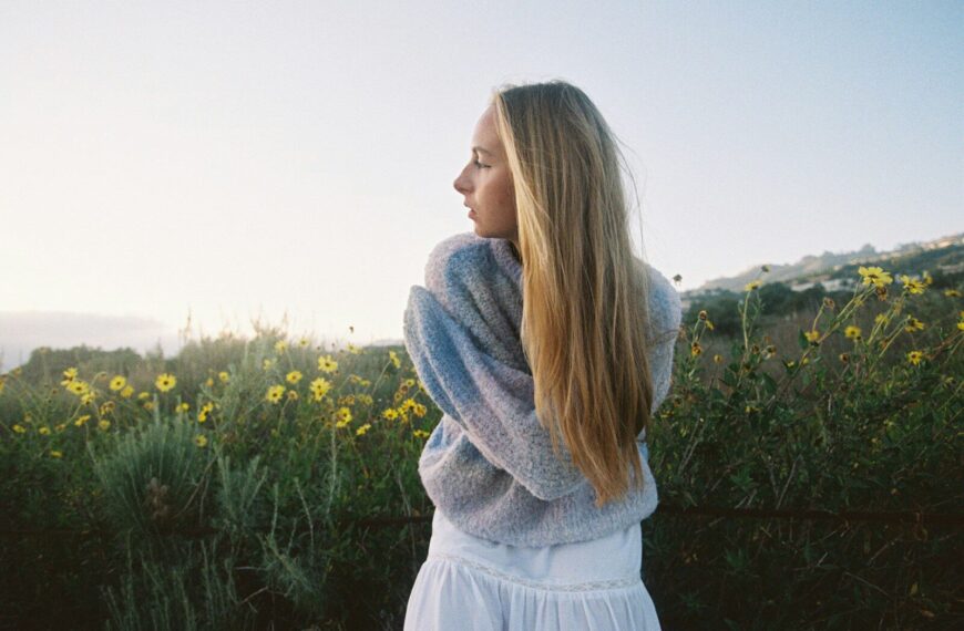 Young woman in a field of yellow flowers