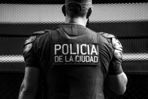 Black and white image of a Buenos Aires city police officer in uniform, reflecting urban security.